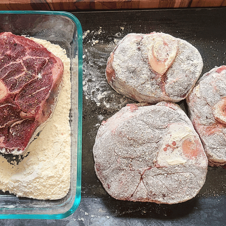 Image of Place the flour in a shallow bowl or deep plate. Season the bison shank generously with salt and pepper. Dredge the shanks with some flour, shake off any excess, and add the meat to the hot fat in the pan.