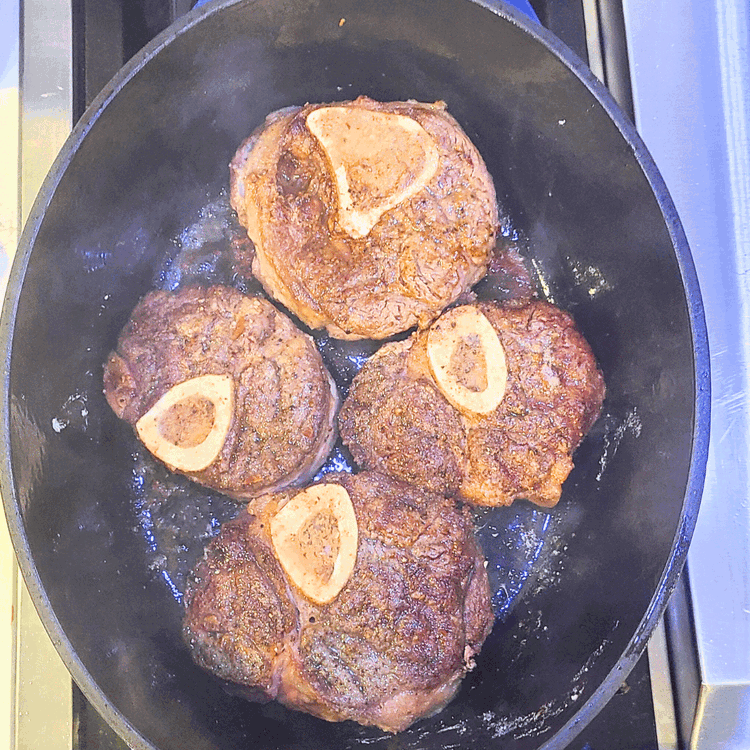 Image of Increase the heat to medium-high and sear the shanks on each side until well browned (about 5 minutes per side).