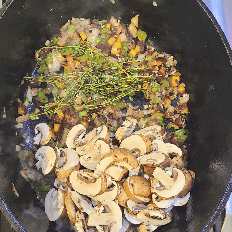 Image of Toss in the garlic, mushrooms and thyme. Continue cooking until the vegetables just begin to brown (about 10 minutes).