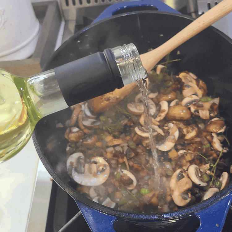 Image of Pour in the wine and deglaze the pot, be sure to scrape up any browned bits from the bottom of the pan.