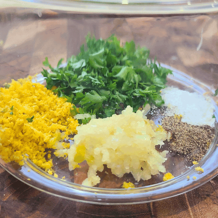 Image of While the meat is cooking, make the Gremolata by combining all the Gremolata ingredients and place in a separate small serving dish. Set aside.