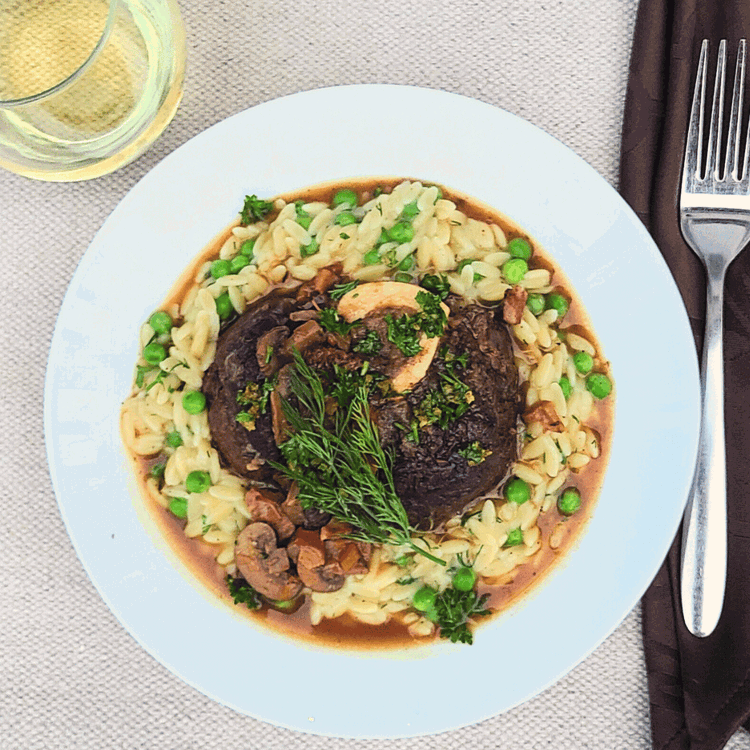 Image of Serve the osso buco by making a well in the orzo, add a portion of the meat and then spoon over the braising liquid. Sprinkle with a small amount of gremolata.