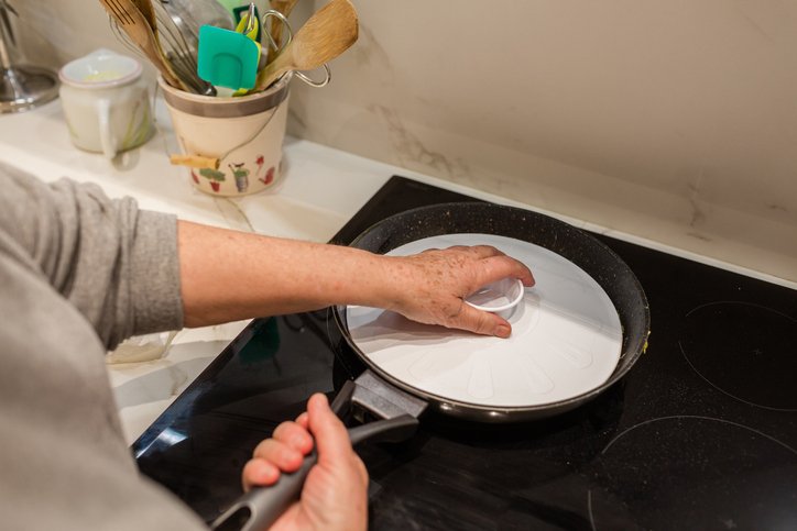 Image of Carefully place a large overturned flat plate or rimless pot...