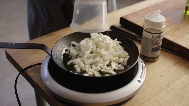 Image of Place the onions in a skillet over medium heat along...