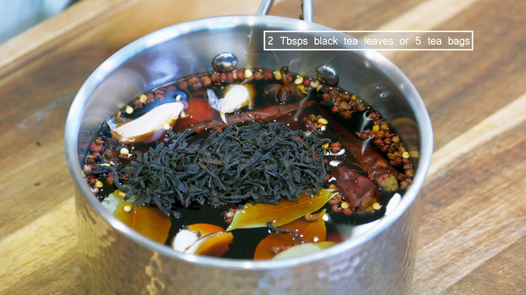 Image of Add the eggs, star anise, bay leaves, Sichuan peppercorns, cinnamon stick, dried red chilies (optional), garlic cloves, soy sauce, dark soy sauce, brown sugar, salt, black tea, and water into the pot. Ulong tea will also work.