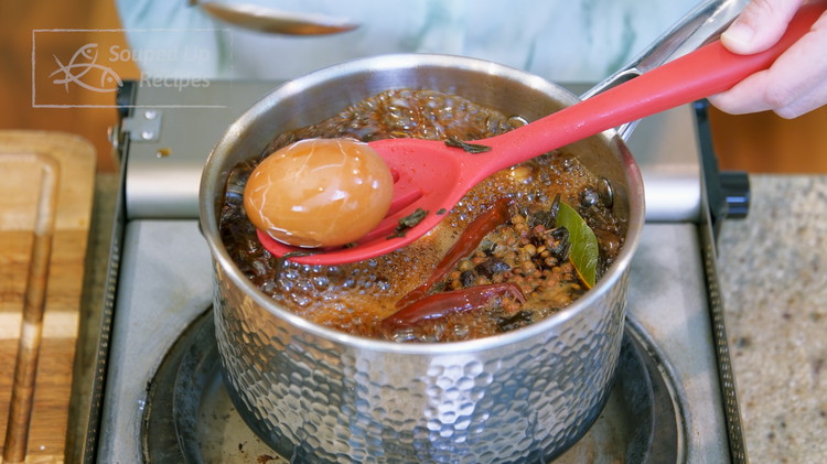 Image of During the boiling, lightly tap each egg with 2 spoons to break the shells. This is an important step for the flavor to infuse deeply. Please be careful; the eggs are not fully cooked yet. If you tap too hard,...