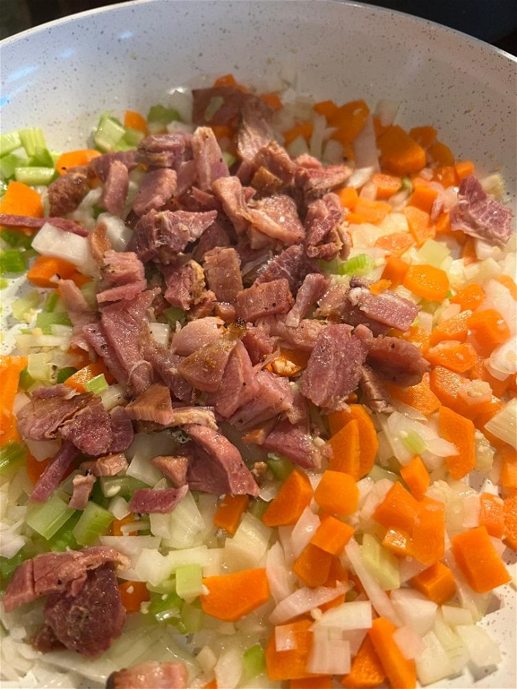 Image of Add bacon fat or oil, carrots, celery, onion, and garlic...