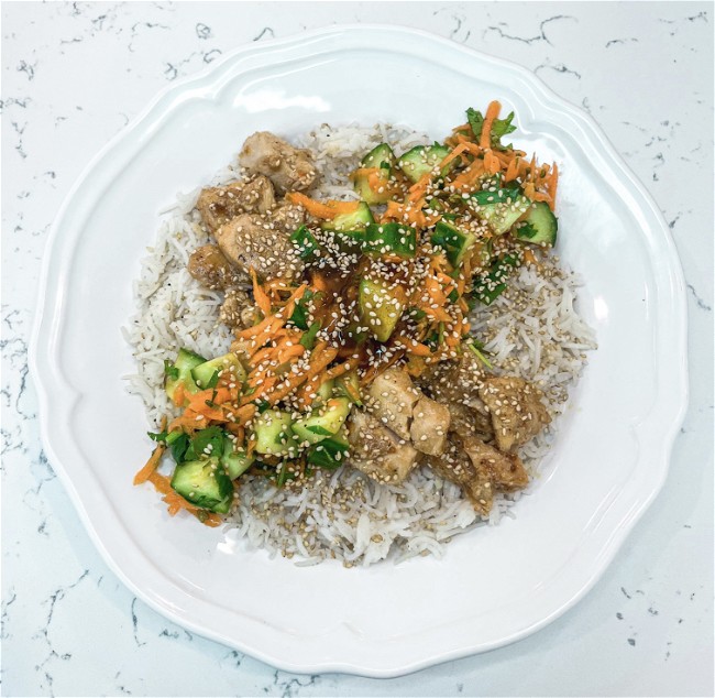 Image of Sweet Chilli Chicken and Cucumber Salad on Garlic Rice