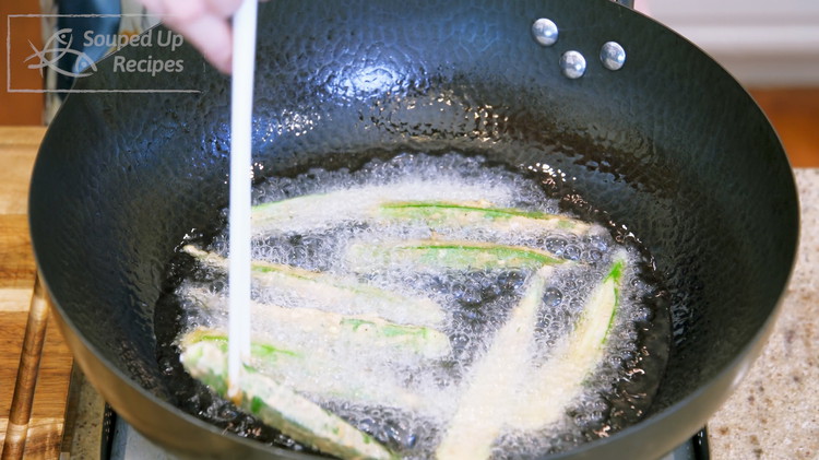 Image of Heat 1 cup of oil in the wok to 380°F / 193°C. Add the okra one by one and fry for 2 minutes or until crispy. Make sure you stir and flip to ensure even cooking. You should fry everything...