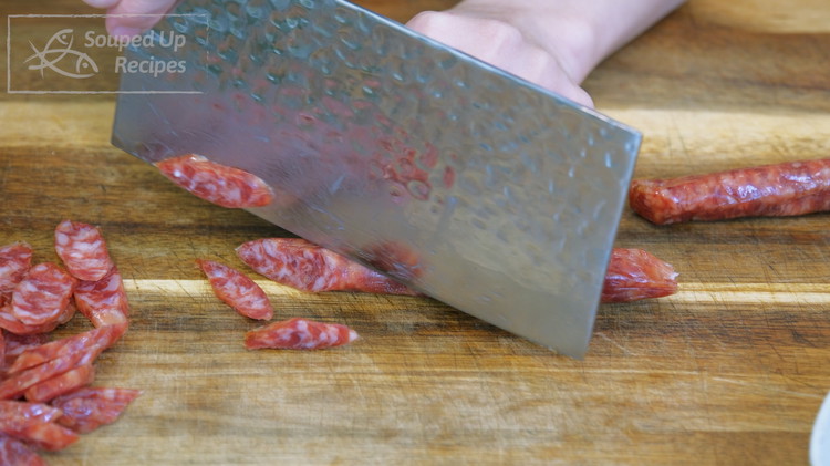 Image of Slice the Cantonese sausage (AKA lap cheong) at a 45-degree angle into thin slices. Cantonese sausage looks like mini salami but you have to cook it before eating. If you can’t find this ingredient, use maple syrup flavored sausage as...