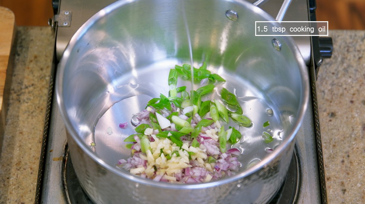Image of Add the diced shallots, garlic, scallion, and 1.5 Tbsps of oil into a saucepan and stir over medium heat for 2-3 minutes or until the aromatics are slightly golden on the edge. 