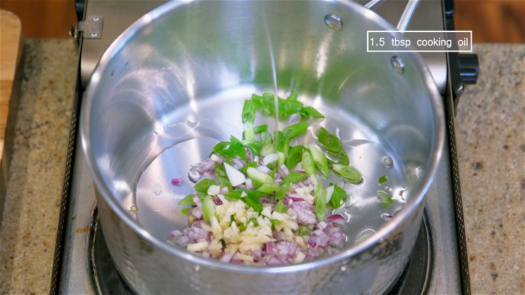 Image of Add the diced shallots, garlic, scallion, and 1.5 Tbsps of...