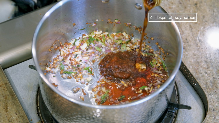 Image of Add 1.5 Tbsp of soybean paste and 2 Tbsps of soy sauce. Keep stirring for a minute.