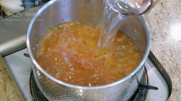 Image of Pour in 3 cups of water. You can use vegetable stock if you want. Turn the heat to high, and it will take a few minutes for it to boil.