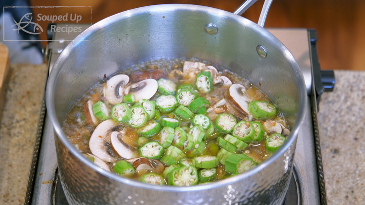 Image of Once the water comes to a boil, add the okra and mushroom slices and continue to boil for 2 minutes.