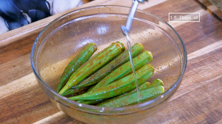 Image of Drizzle 1.5 Tbsps of cooking oil and stir to coat the okra.