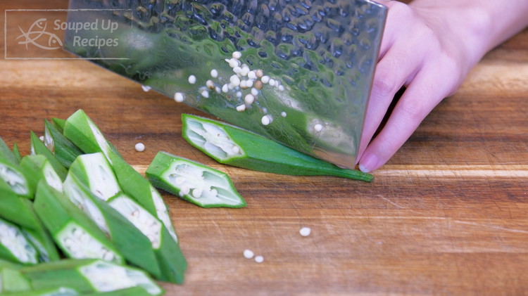 Image of Cut off the calyx of the okra and slice each pod into 3 pieces at a 45-degree angle. Set it aside.