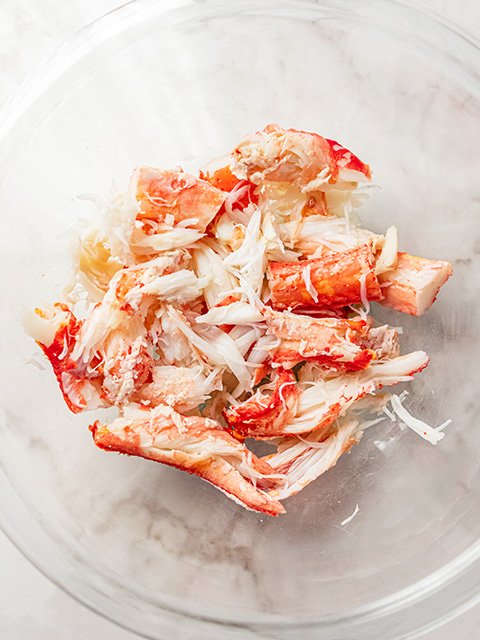 Image of Remove crab legs from baking pan and transfer to a...