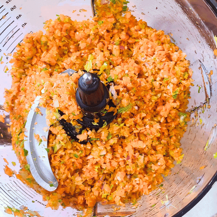 Image of In the bowl of your food processor combine the carrots, celery and garlic, pulse until they are finely diced. Add them to the pot and let them cook until slightly softened, about 5 min.