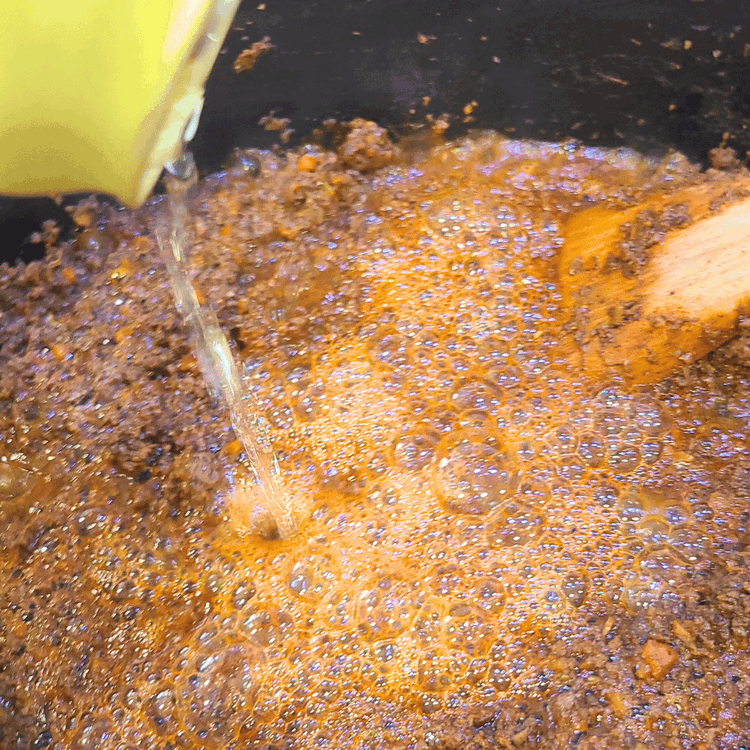 Image of Add the beer scraping the bottom and sides of the pot then let it reduce down for about 5 min.