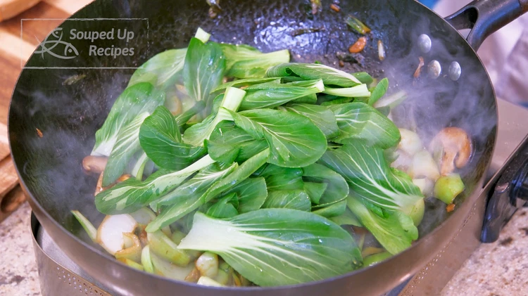 Image of Add the bok choy leaves and continue to stir until the leaves are wilted. Serve as a side dish.