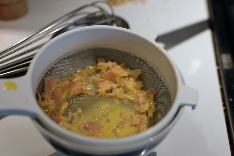 Image of Strain sauce to separate out the shallots.  It will make for a more elegant looking sauce.  I like to keep and then add some of the shallots on top of the protein both for texture and the nice acid kick...