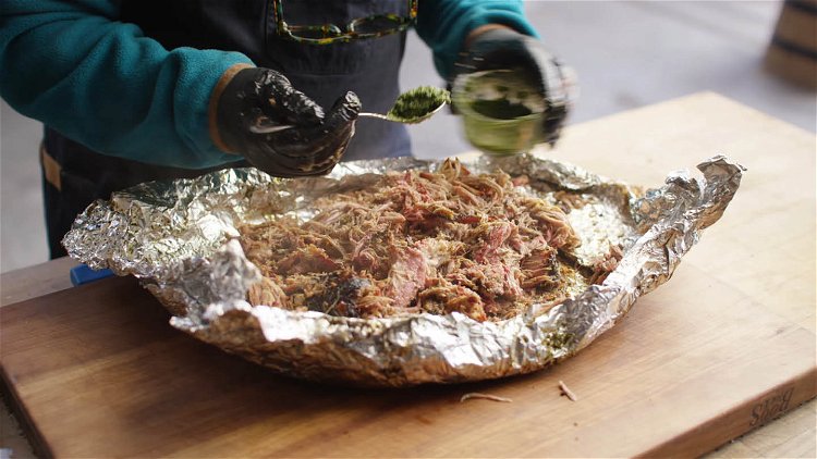 Image of Shred the pork and serve topped with more chimichurri.