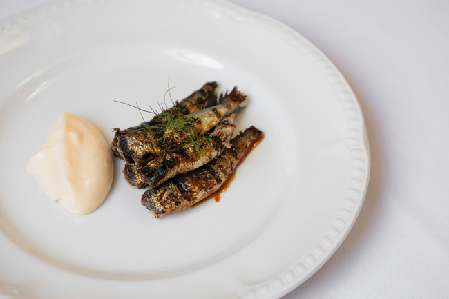 Image of grilled sardines, orange & chilli gastrique w/ mount zero olive oil