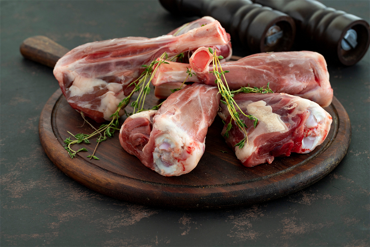 Image of Season the lamb shanks generously with salt and pepper.