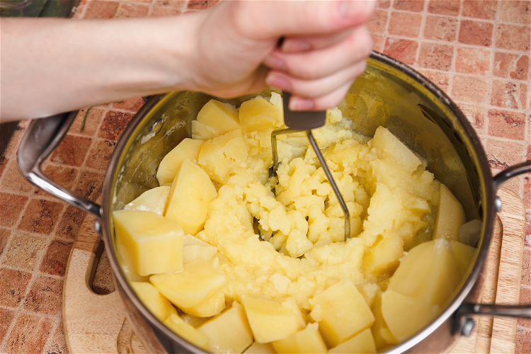 Image of Use a potato masher or a fork to mash the...