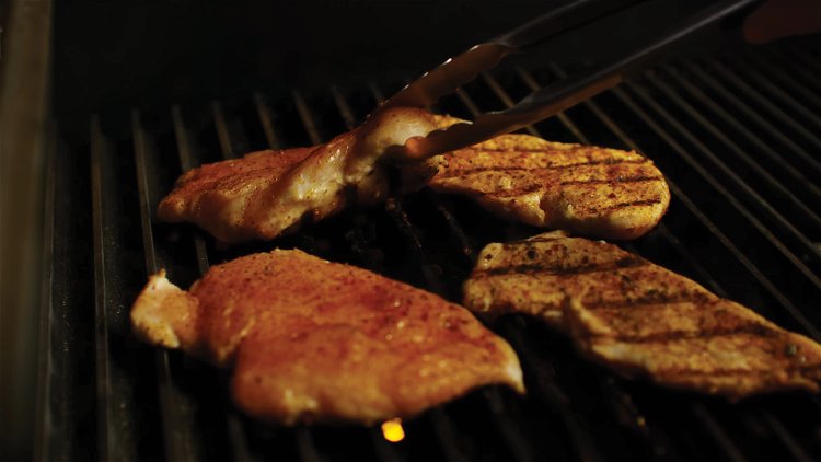 Image of Place the chicken breasts on the GrillGrates, directly over the...