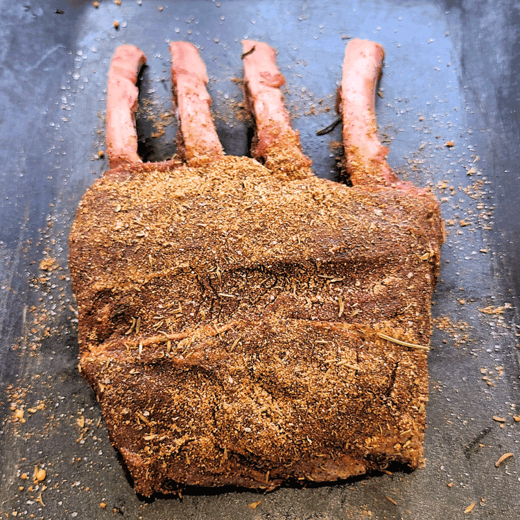 Image of Coat the elk rack generously with the dry rub, ensuring it's evenly distributed.