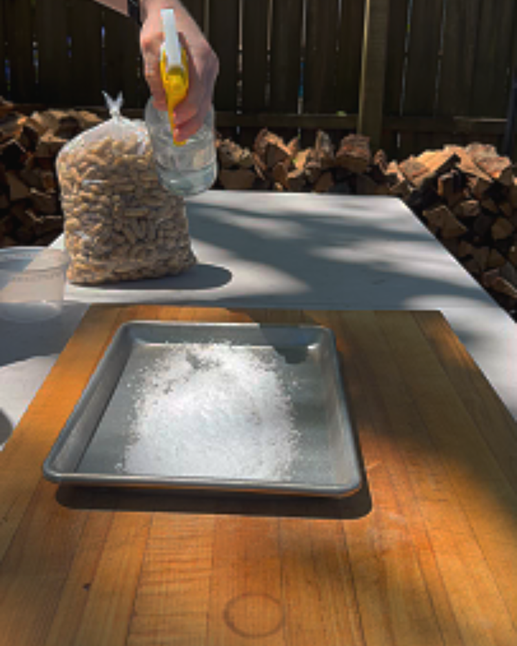 Image of Pour your salt on a sheet pan, distribute in a single layer, and spritz lightly with water until salt is just moist. Then put your pan the smoker