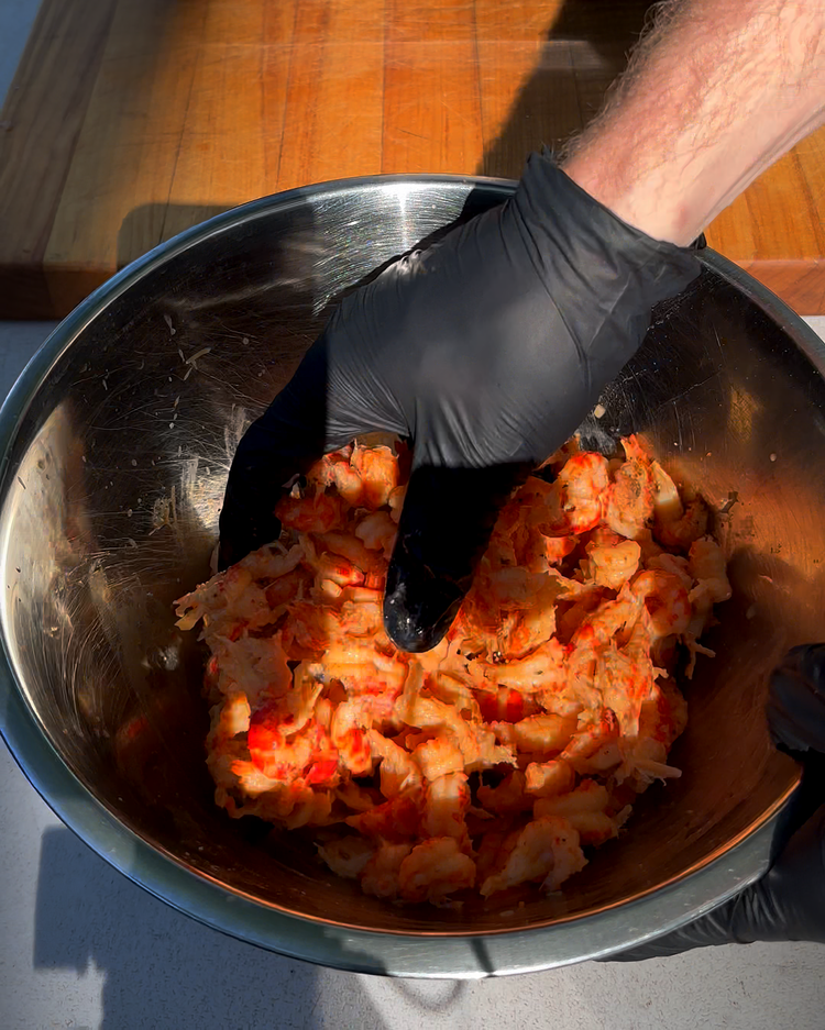 Image of Next, add the crawfish and all of the fat / liquid from the bag to a bowl with the salt, black pepper, cayenne and hot sauce and give it some mixy mixy