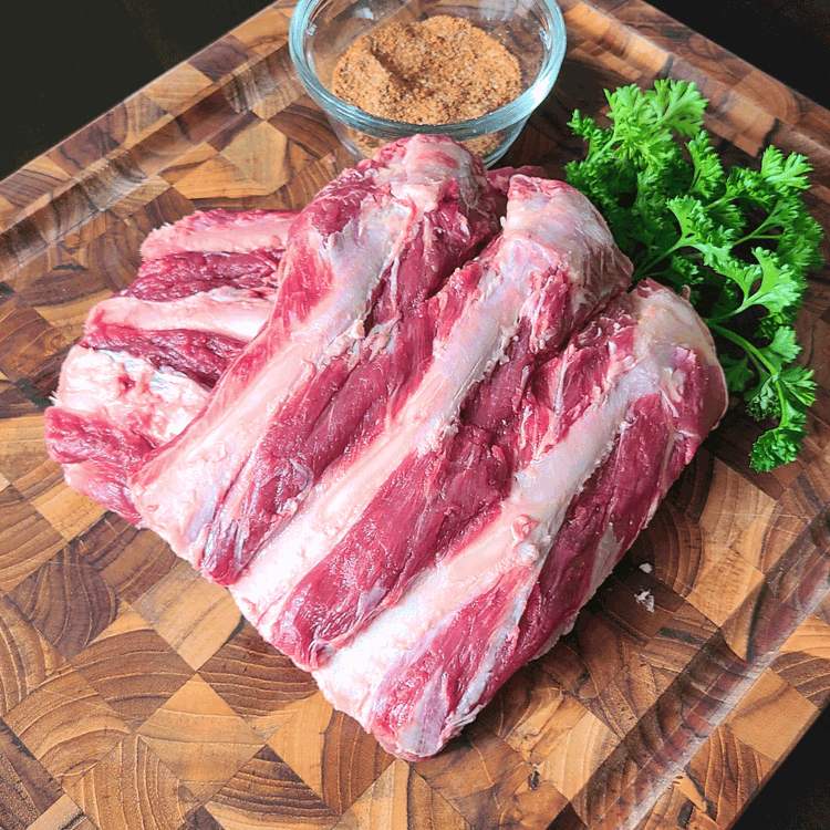 Image of Prep the Ribs: Start by removing the membrane from the back of the ribs. This helps the rub penetrate the meat better. TIP: use a small knife to pry up a piece of it, then grip it with a paper...