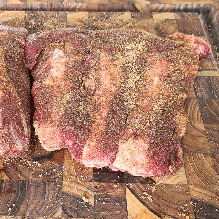 Image of Apply the Rub: Generously apply the dry rub to both sides of the ribs, ensuring an even coating. You can adjust the amount of rub based on your personal preference.