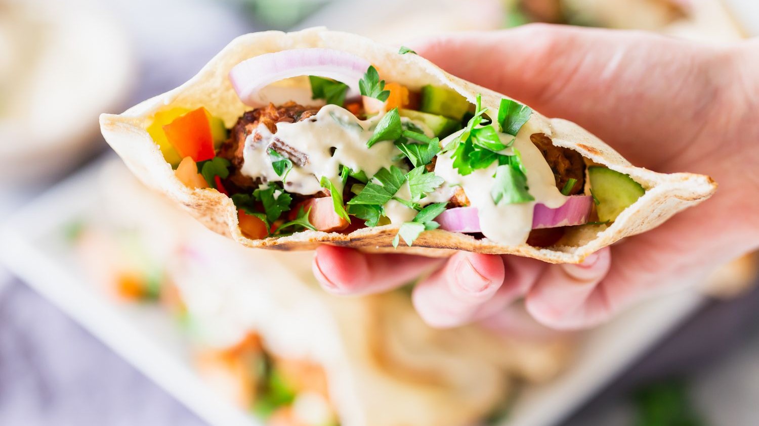 Image of Baked Falafel Pitas with Hummus and Tahini Sauce