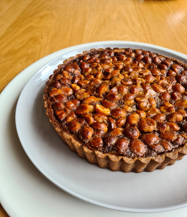 Image of golden macadamia tart with extra virgin olive oil pastry