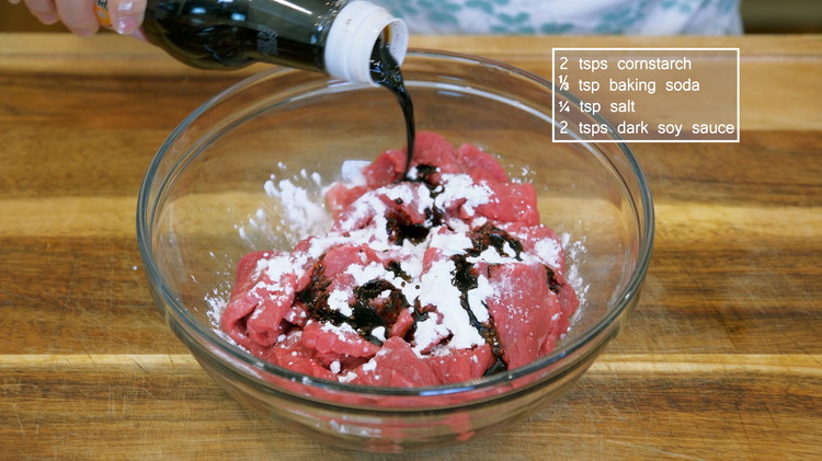 Image of Season the beef with 2 tsp of cornstarch, 1/3 tsp of baking soda, 2 tsp of dark soy sauce, and 1/4 tsp of salt. Mix well. Make sure you get in between each slices and allow the seasonings to infuse evenly.