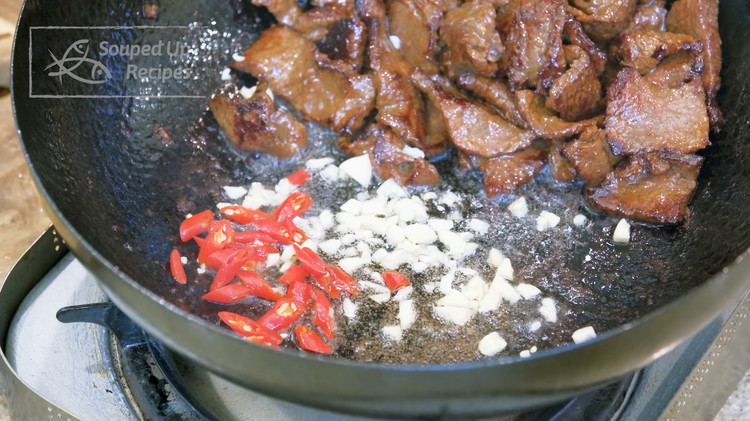 Image of Add the marinaded beef and cook for 2 minutes or until all the meat is nicely charred. Push it to the side and let the oil run to one side so you have room to add the minced garlic and thai bird eye...
