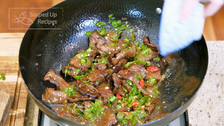 Image of Stir the sauce to loosen the cornstarch, then pour it into the wok. Mix thoroughly until the sauce thickens.