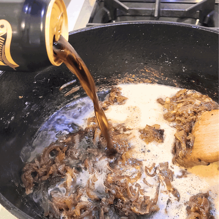 Image of After the flour has browned, pour beer into the pot and deglaze with a wooden spoon. Make sure to get any browned bits off the bottom and sides.