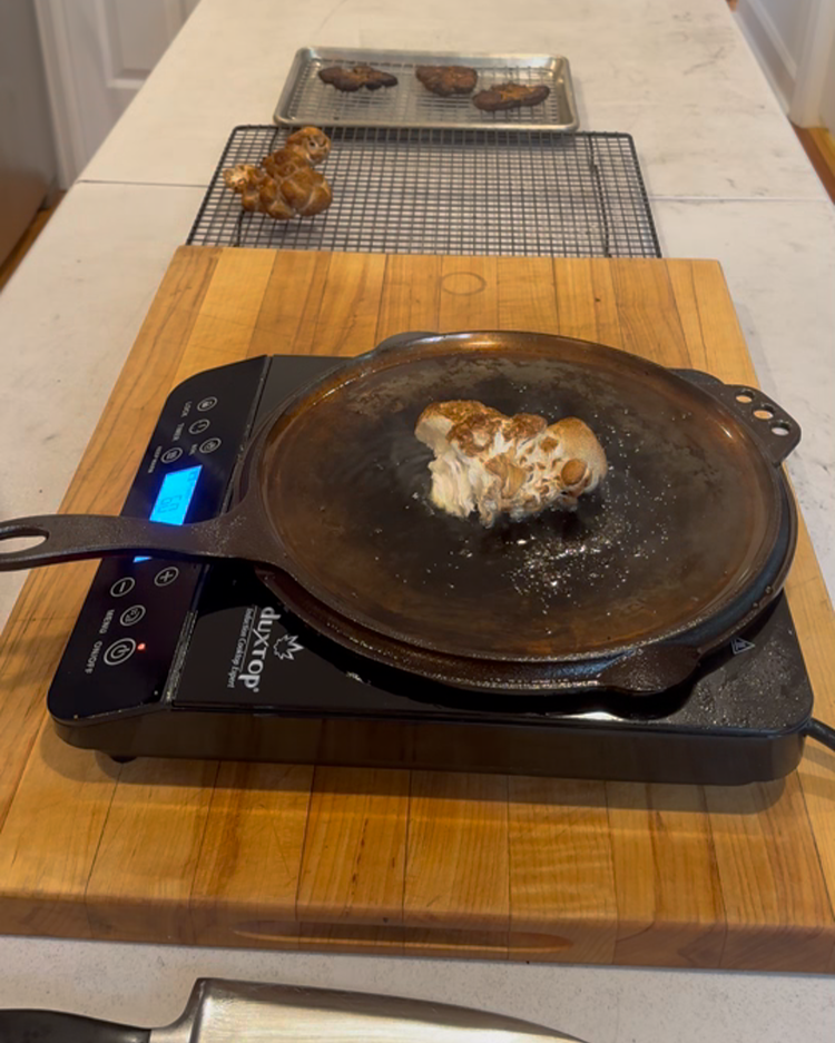 Image of Once your oil is simmering, add 1 mushroom and press down with the second skillet