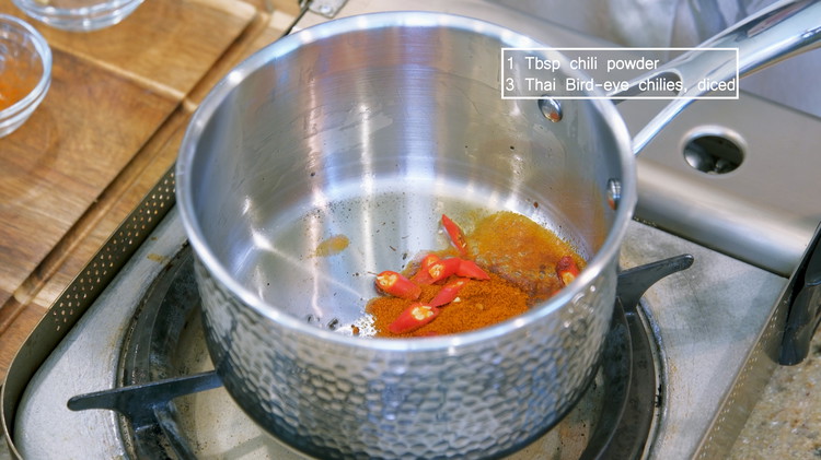 Image of To the saucepan, add 1 tbsp of chili powder and some diced Thai bird-eye chilies and stir well. Sichuan recipes like to use dried and fresh, mild , and spicy chilies to make the dish more complex in all dimensions. You can adjust the amount depending on your tolerance.