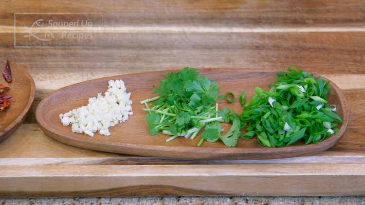 Image of Besides that, you will also need to dice some scallions, cilantro, and garlic, and set everything aside.