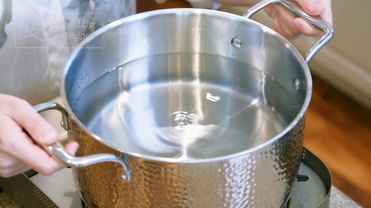 Image of At this point, we will fill a separate pot with water and heat it over medium heat. We will use it to boil the noodles later.
