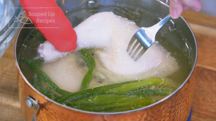 Image of Check back on the chicken by poking the thickest part of the meat. If there is no pink juice coming out, the chicken is safe to eat. Take the chicken out of the pot and chill it in the ice bath for a few...