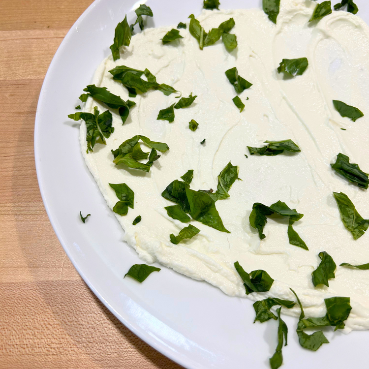 Image of Spread chilled herby Greek yogurt in a thin layer on the bottom of the plate.