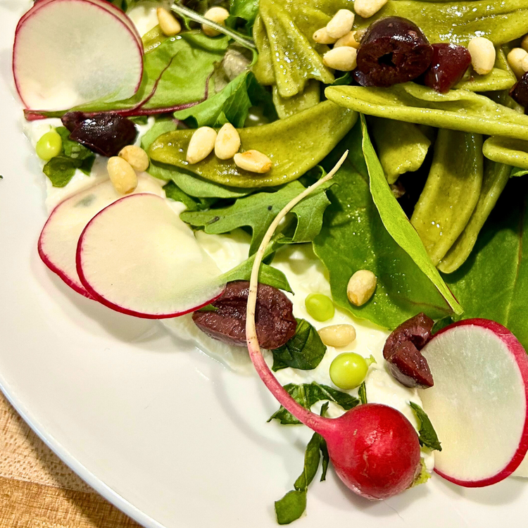 Image of Add radish slices, toasted pine nuts, and peas. Serve immediately.