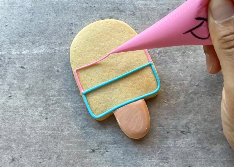 Image of Next, use light pink to outline the middle third of the popsicle.  